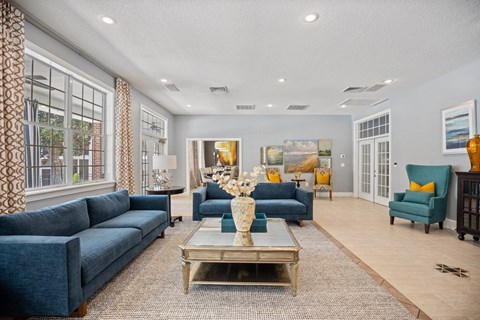 A living room with a blue couch and a coffee table.