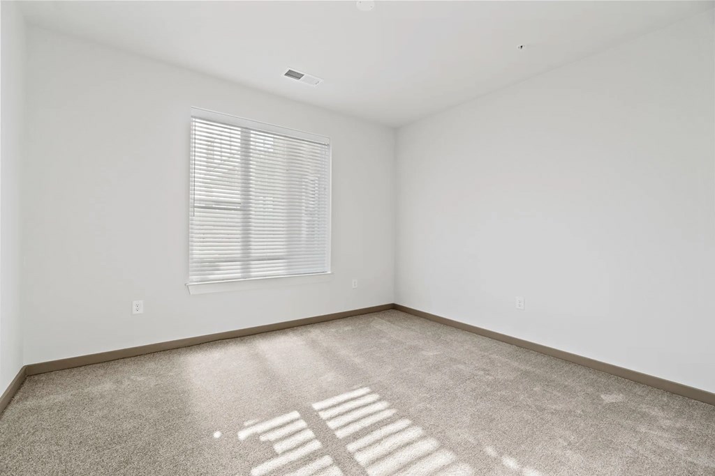 a white room with a window and a carpetat Metropolis Apartments, Glen Allen Virginia