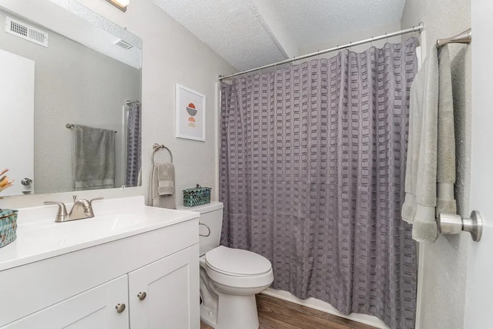 a bathroom with a shower and a toilet and a sink at Village 1373, Greensboro