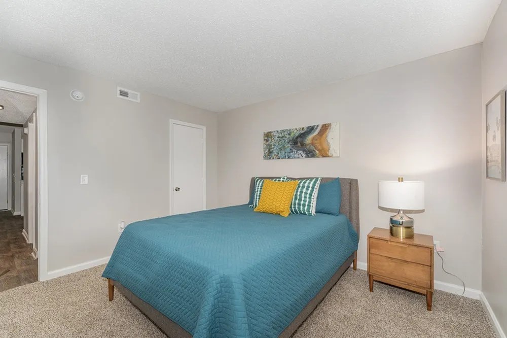 a bedroom with a bed and a night stand at Village 1373, Greensboro, 27455