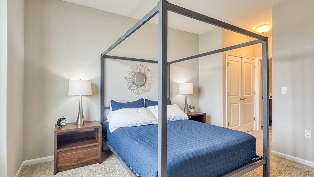 a bedroom with a large bed and a mirrored closet