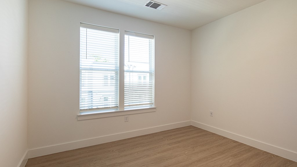a bedroom with two windows and a wooden floor at Ainsworth, Virginia