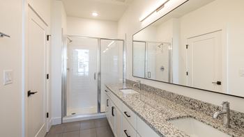 a bathroom with granite countertops and a large mirror at Ainsworth, Virginia,3228