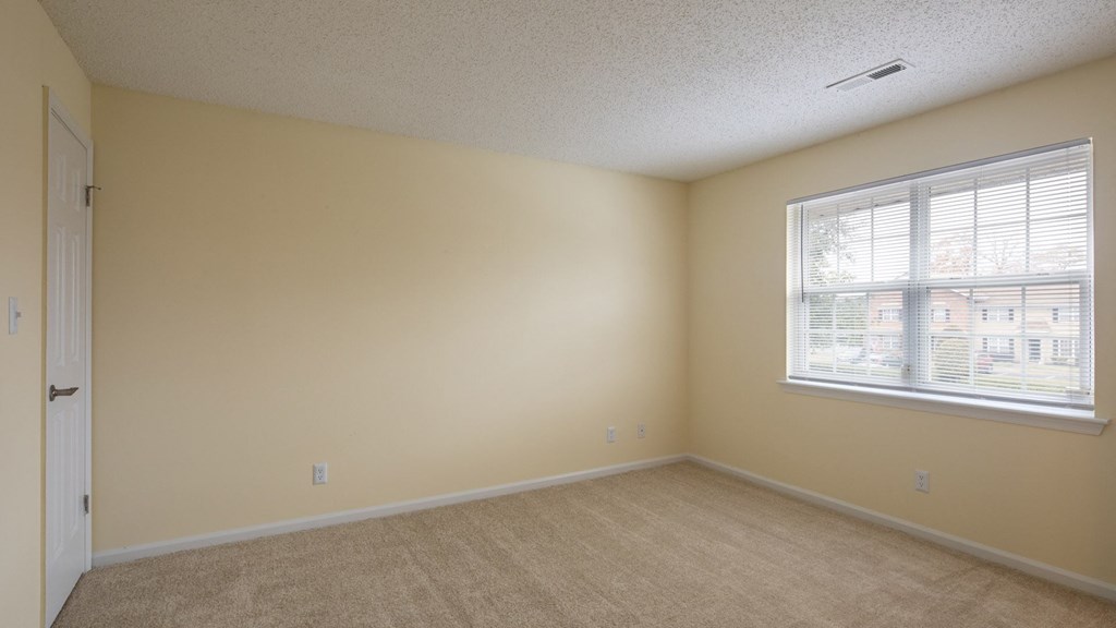 A room with a window and a door.