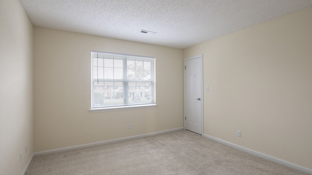 A room with a window and a door.