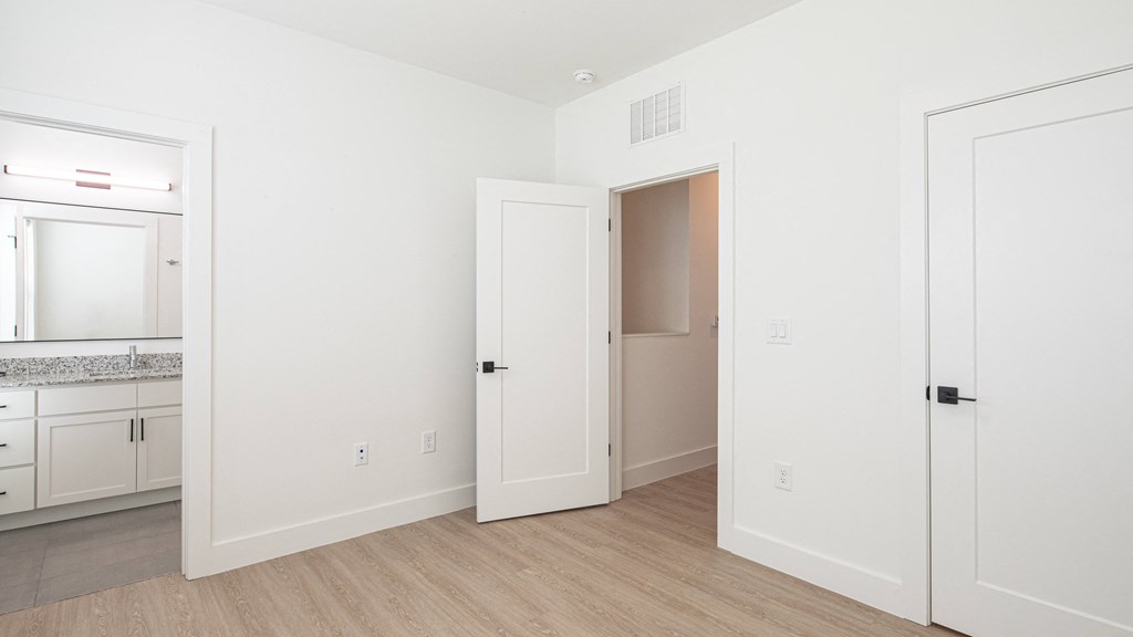 a bedroom with white walls and hardwood floors at Ainsworth, Richmond, VA