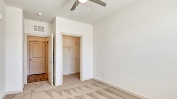 a renovated living room with white walls and a ceiling fan at The Walker Virginia Center, Glen Allen, VA