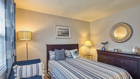 a bedroom with a bed and a chair