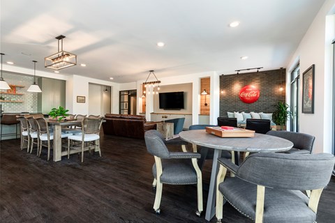A modern dining room with a Coca-Cola logo on the wall.