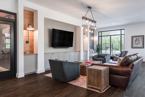 A modern living room with a flat screen TV and a large sectional sofa.