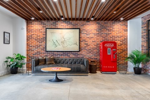 A room with a red Coca-Cola vending machine.