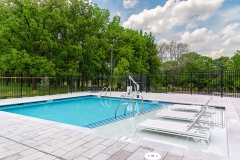 A pool with a diving board and a slide.