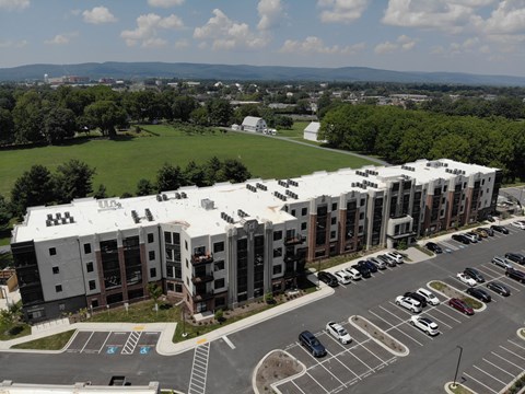 A large building with a parking lot in front of it.