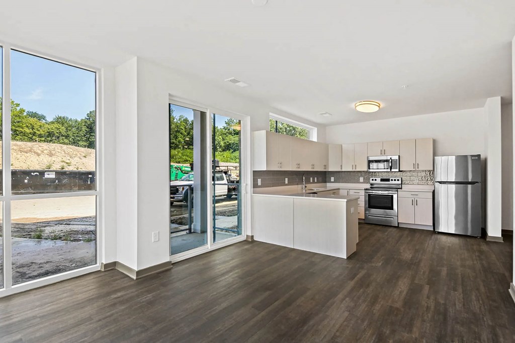 a kitchen with a stainless steel refrigerator and a door to a patioat Metropolis Apartments, Glen Allen, VA 23060