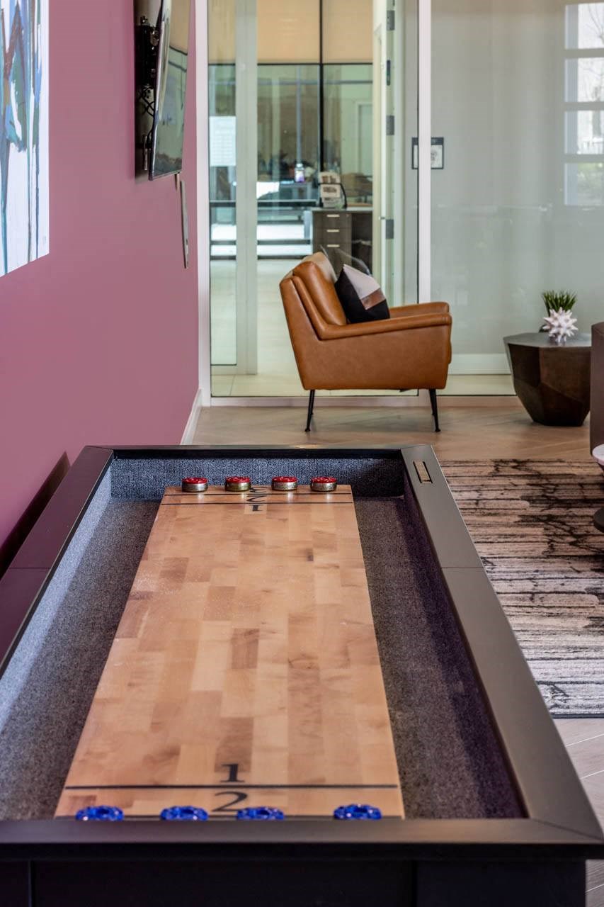 a foosball table in a living room with a chairat Centro at Pine Nash, Wilson, NC