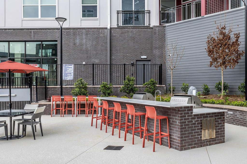 a patio with a bar and chairs and a building in the backgroundat Centro at Pine Nash, North Carolina, 27893