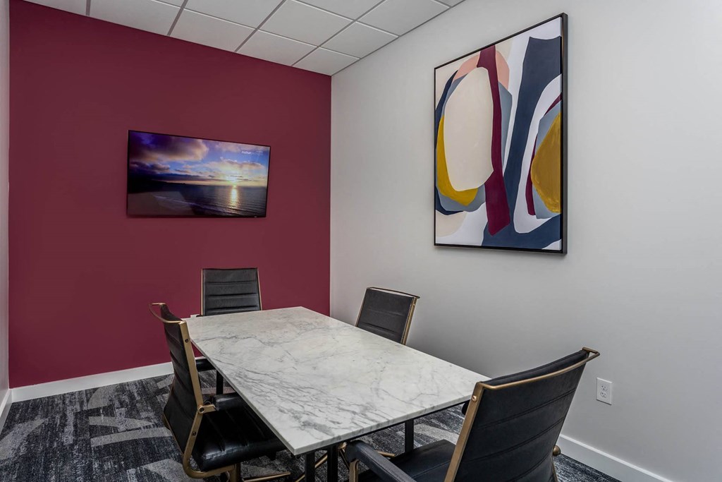 a conference room with a table and chairs and a painting on the wallat Centro at Pine Nash, Wilson, NC, North Carolina, 27893