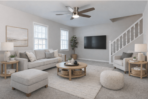 A living room with a grey couch, a coffee table, and a television.