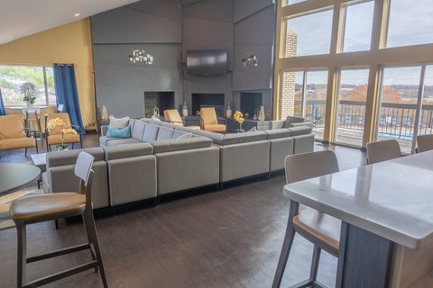 A modern living room with a grey sofa and a fireplace.