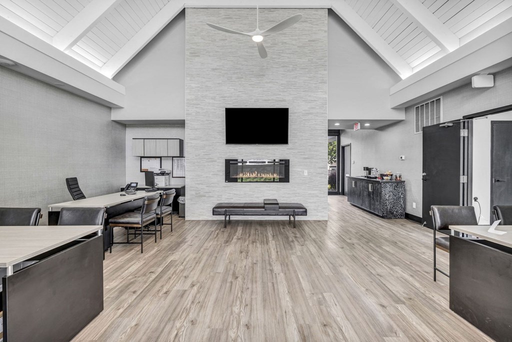 A modern living room with a fireplace and a television.
