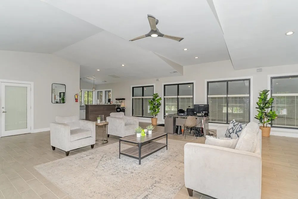 a living room with white furniture and a ceiling fan at Village 1373, North Carolina, 27455