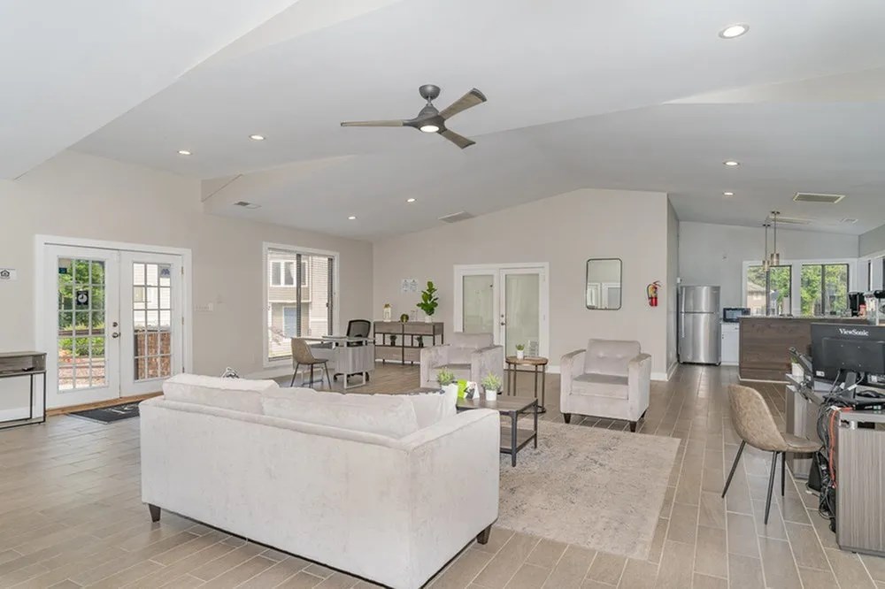 a living room with a white couch and a ceiling fan at Village 1373, North Carolina