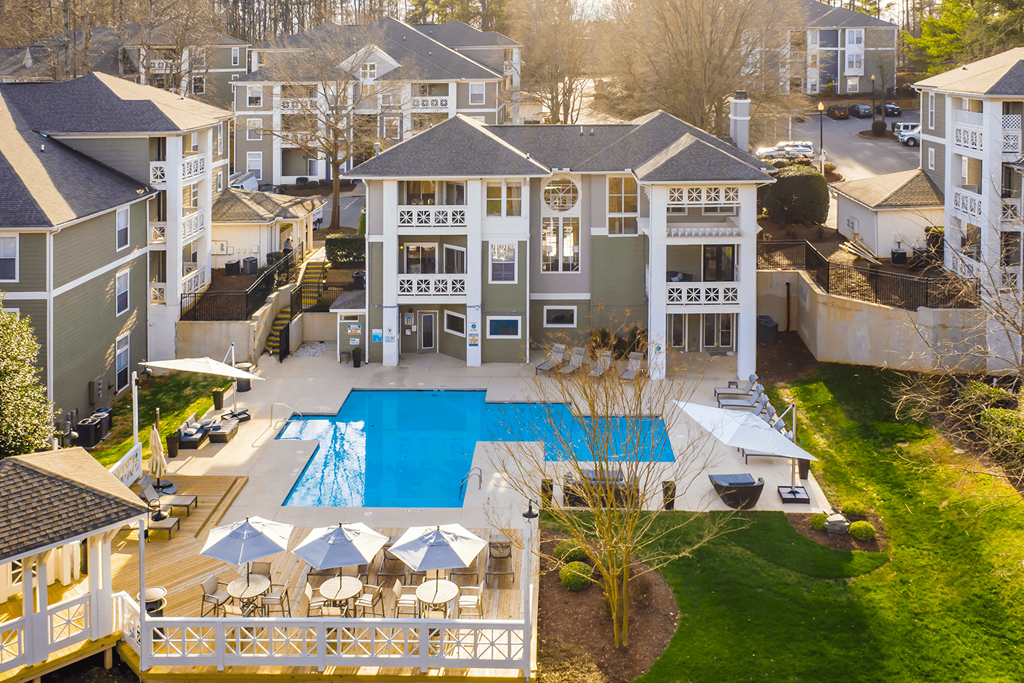 A large building with a pool in front of it.