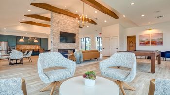 a living room with chairs and a table and a fireplace at Allure at Edinburgh, Virginia