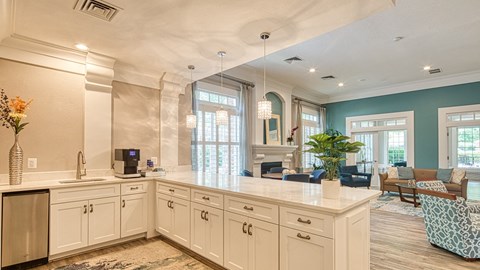 a large kitchen with white cabinets and a counter top