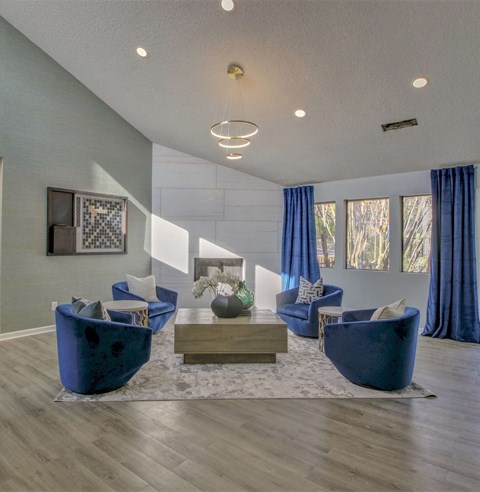 A living room with blue chairs and a coffee table.