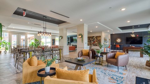 A living room with a yellow chair and a black coffee table.