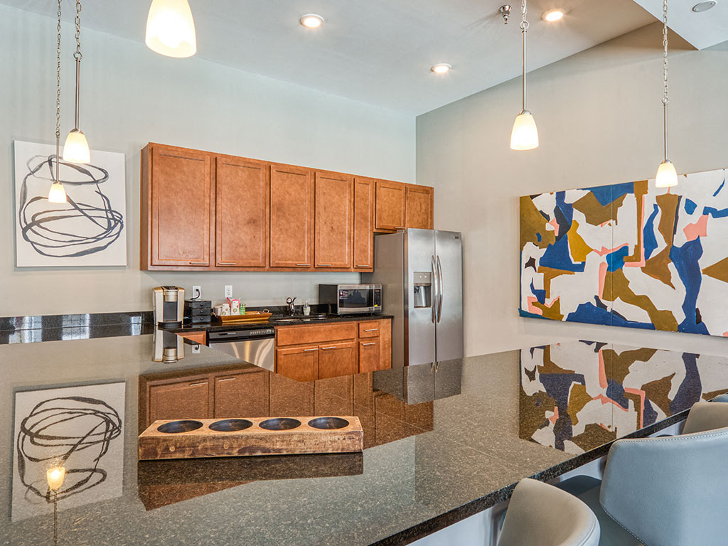 A modern kitchen with wooden cabinets and a large island.