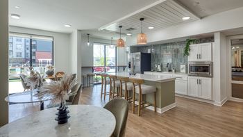 A modern kitchen with a dining table and chairs.
