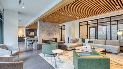 a living room with couches and chairs and a fireplace