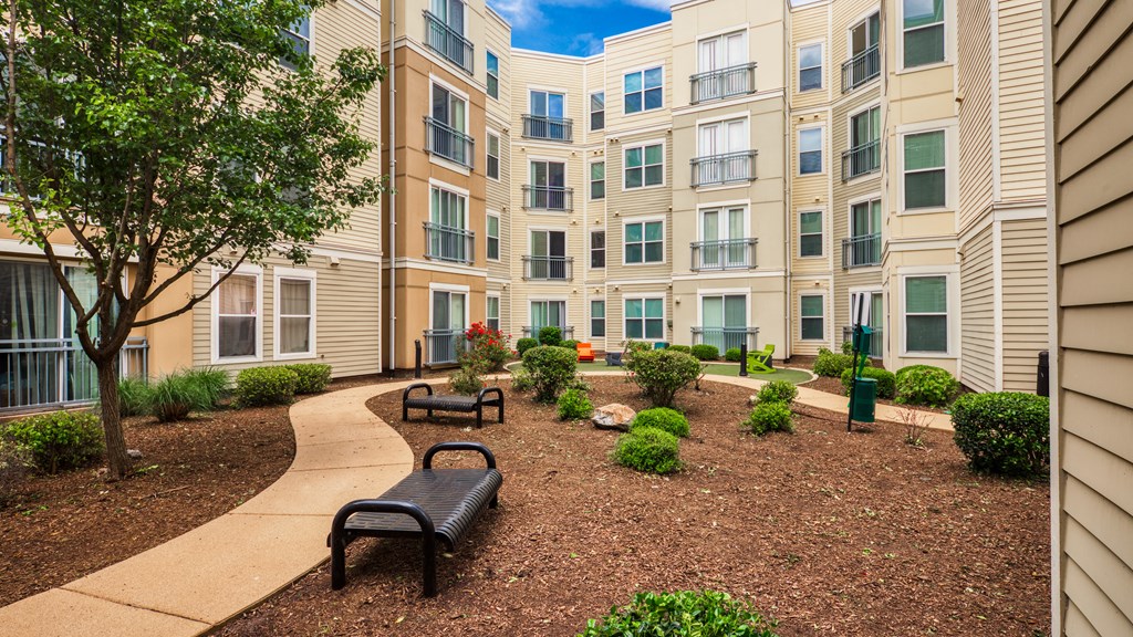 an apartment building with a courtyard and benches at Proximity at ODU, Norfolk, Virginia