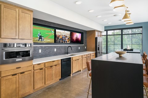 A modern kitchen with wooden cabinets and a large island.