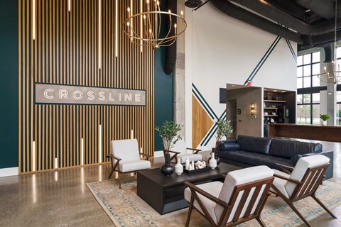A living room with a sofa, chairs, and a coffee table with a sign that says "CROSSLINE".