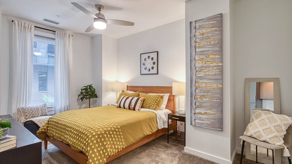 a bedroom with a bed and a ceiling fan