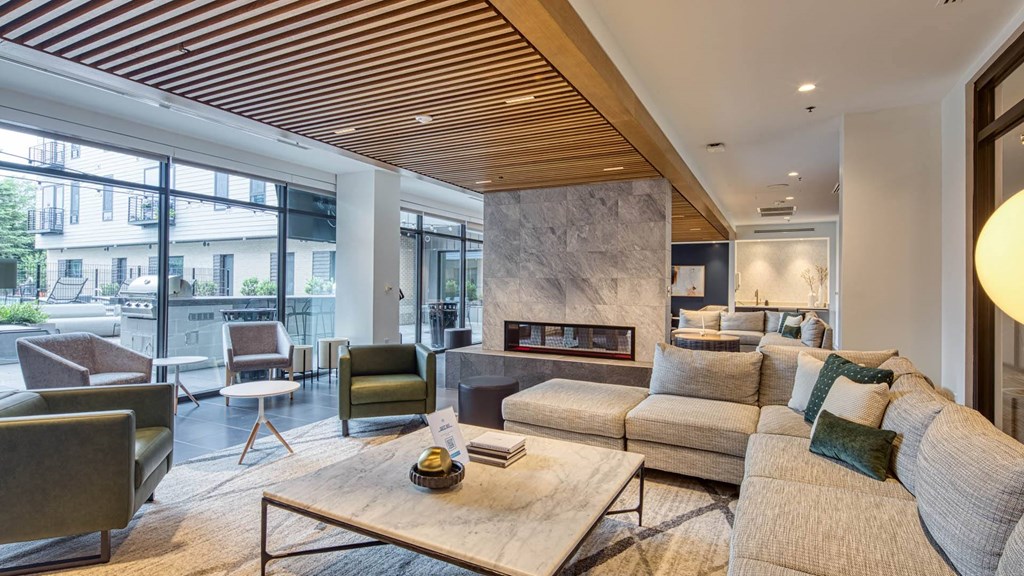 a living room with couches and chairs and a fireplace