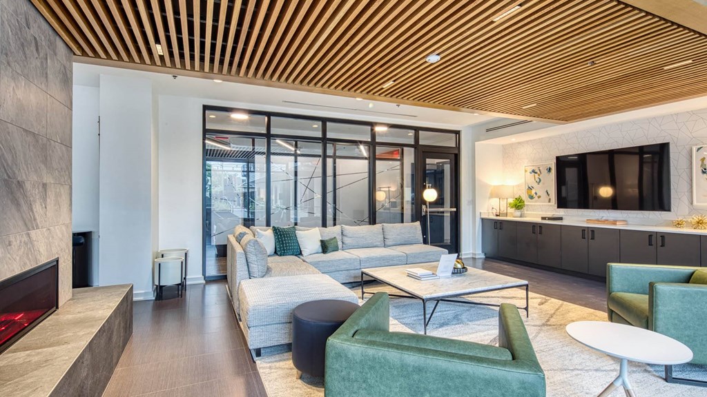 a living room with couches and chairs and a television