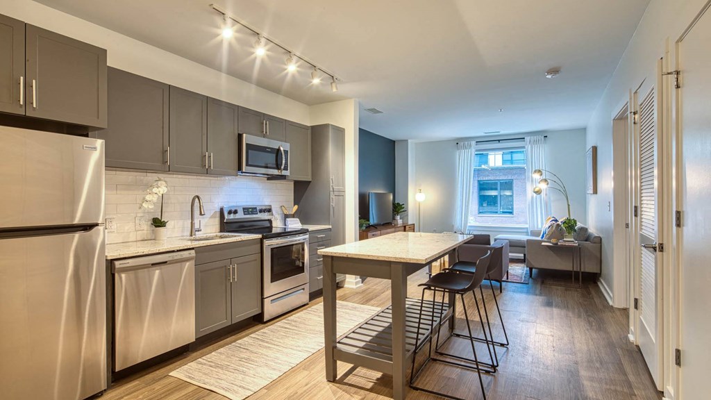 a kitchen with stainless steel appliances and a table