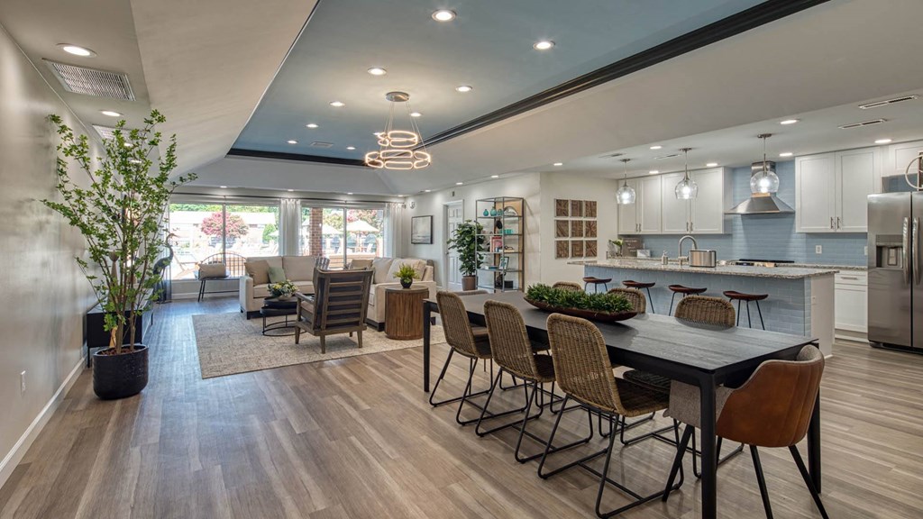 a kitchen and living room with a table and chairs