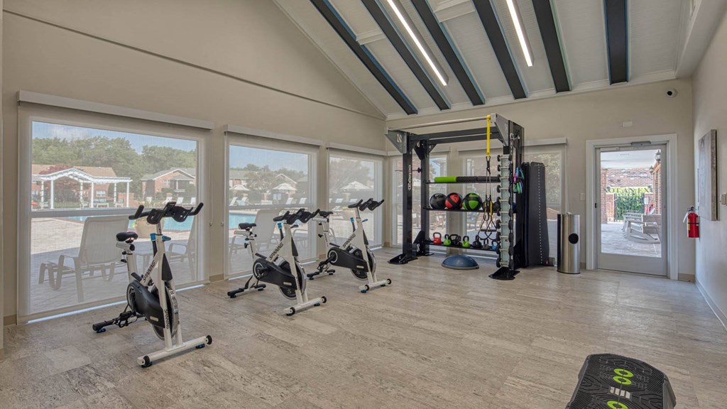 a gym with a view of the pool and patio