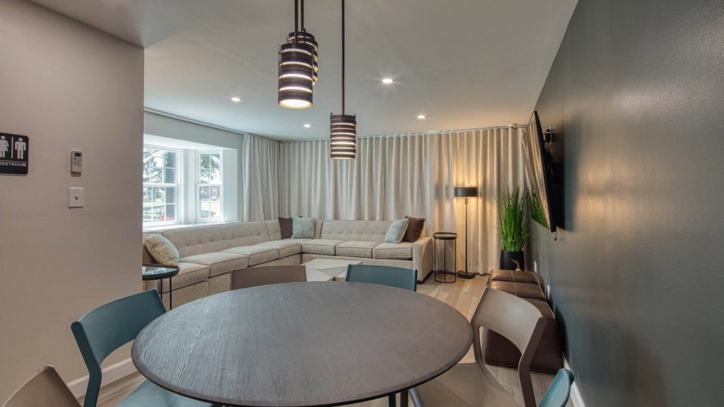 a living room and dining room with couches and a table