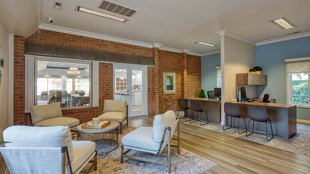 a living room with furniture and a brick wall