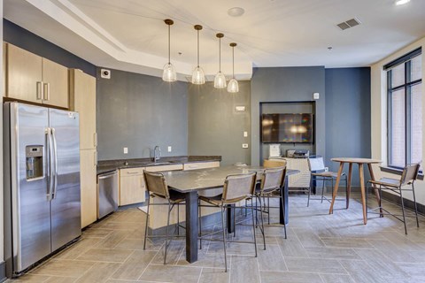 a kitchen with stainless steel appliances and a table with chairs