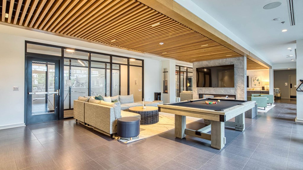 a large living room with a pool table