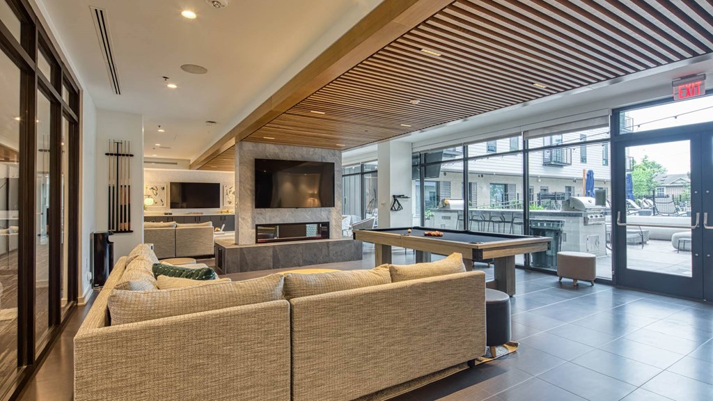 a game room with a pool table and couches