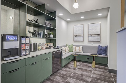 A kitchen area with green cabinets and a bench.