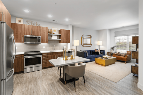 A modern kitchen with a dining table and chairs.